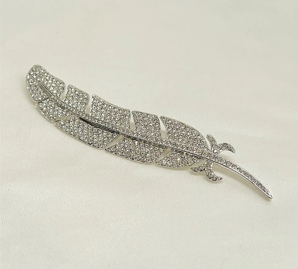 Classic signed Carolee rhinestone encrusted feather designer brooch.